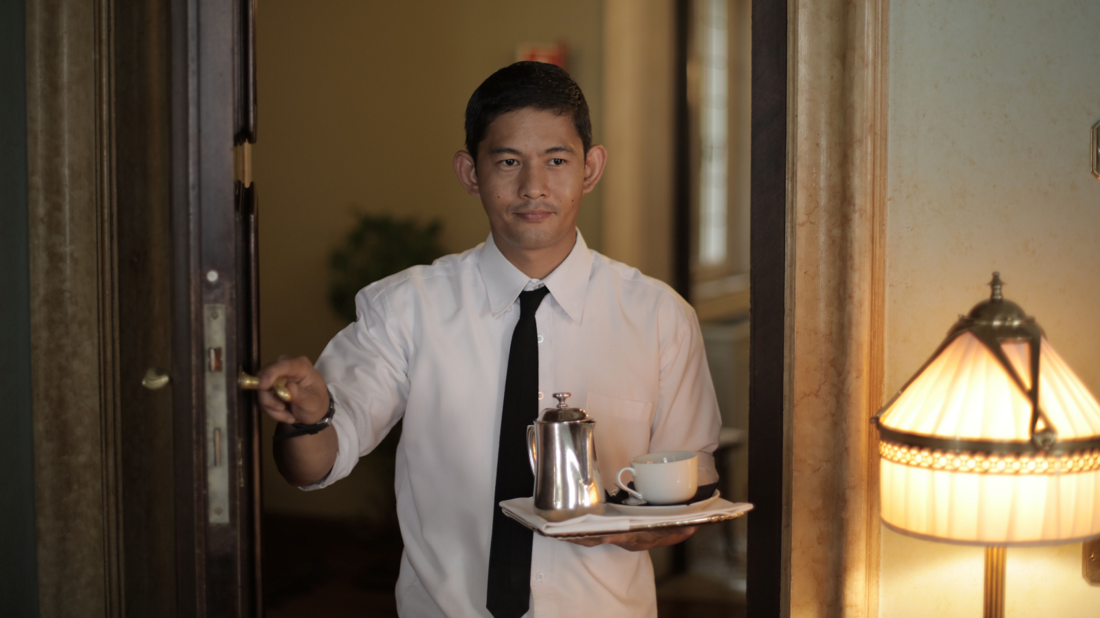 A waiter carrying coffee