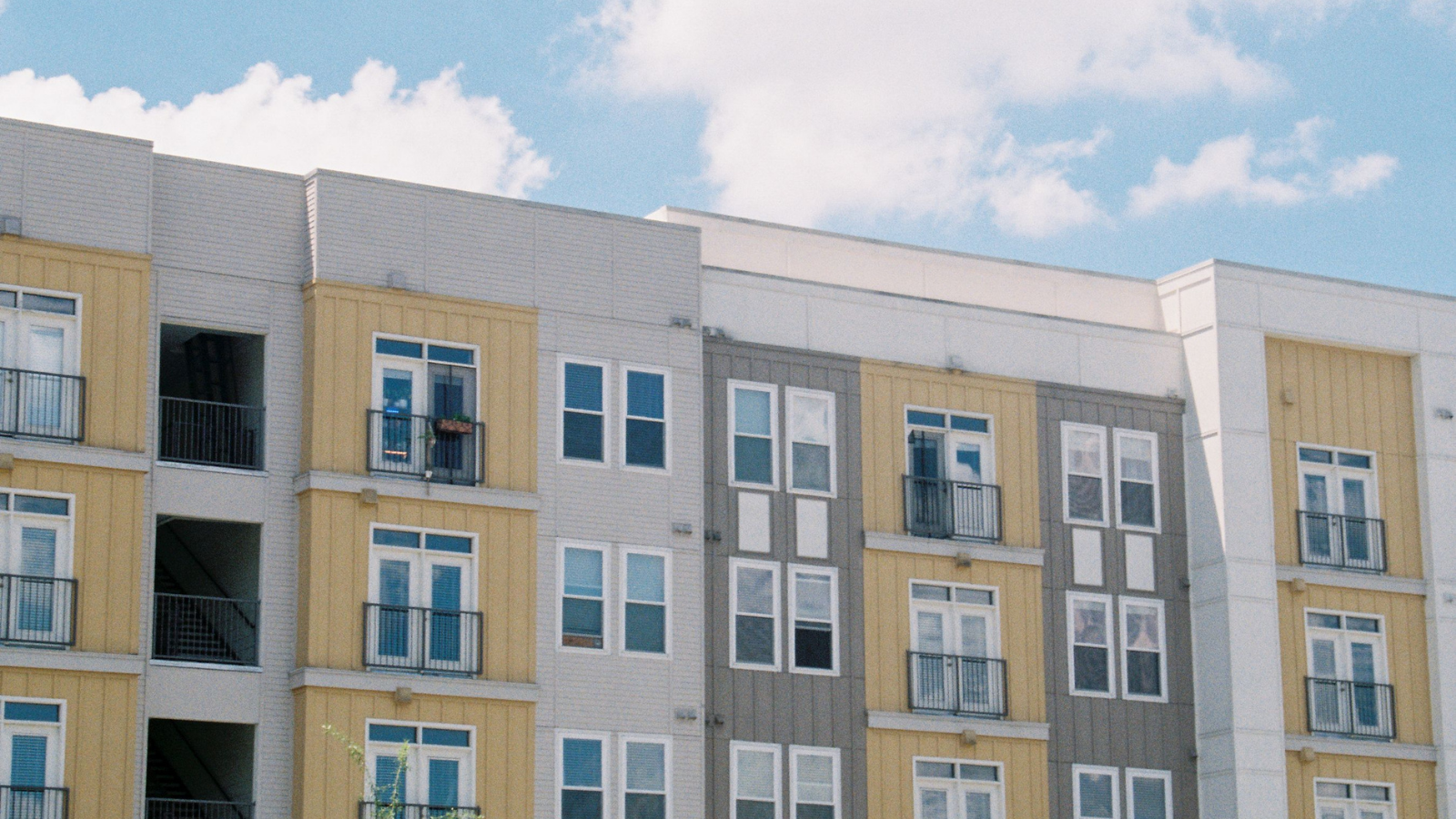 Apartment Building Had Its Share Of Characters, But A New Neighbor Started Harassing Everyone And Disrupted The Peace A yellow apartment building