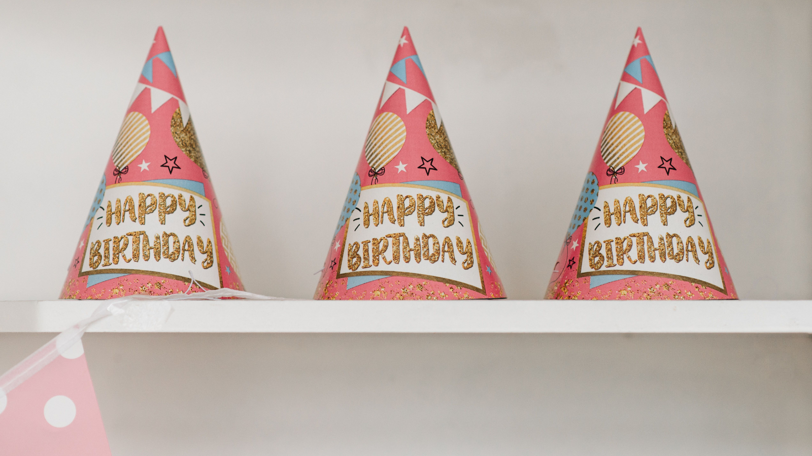 Three pink birthday hats