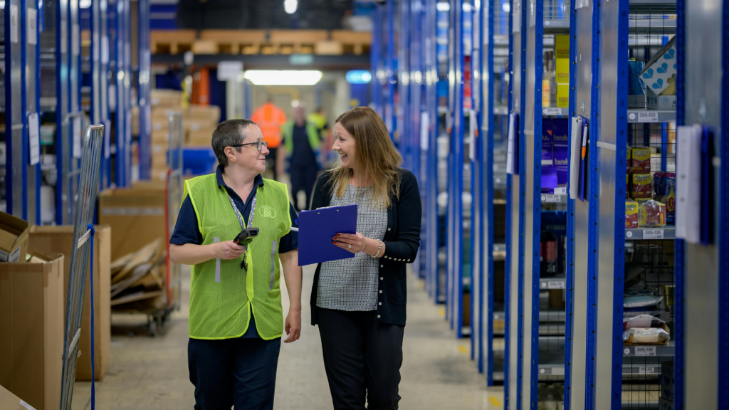 A Rude Customer Made An Unsafe Request — The Employee Refused, Choosing Safety Over Giving In Employee and manager walking at a warehouse aisle