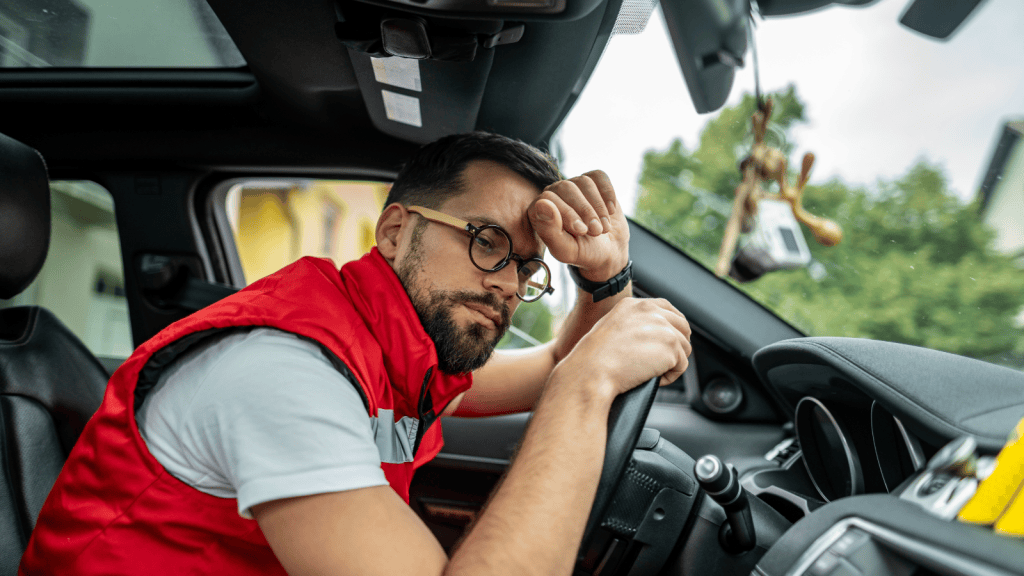 Frustrated man in car leaning over steering wheel