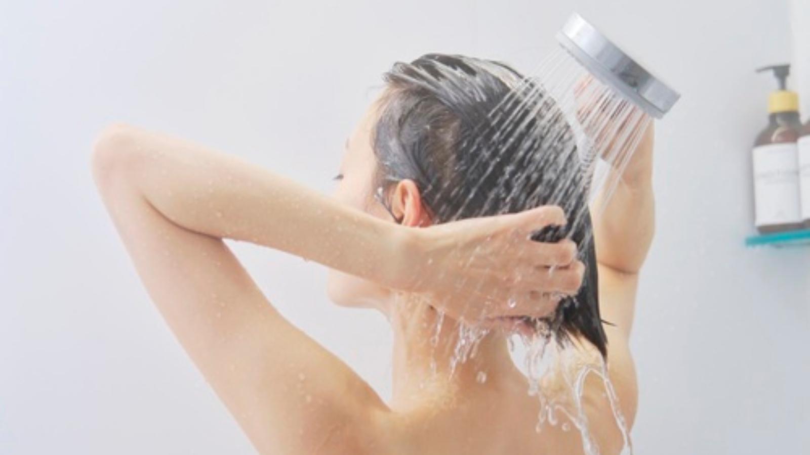 They Agreed to Shower Notification Texts to Share Hot Water—Then Received Messages Tracking Their Daily Hygiene Schedule Woman in a hot shower