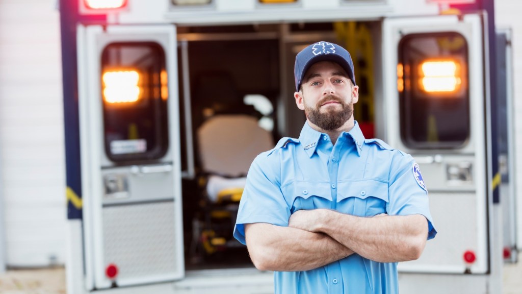Paramedic standing at his ambulance
