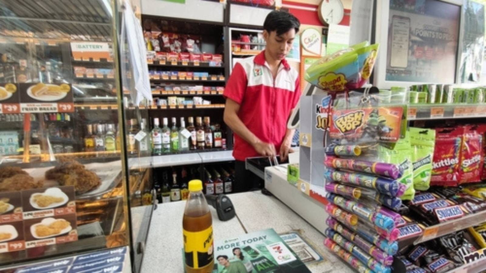 Young man working at convenience store