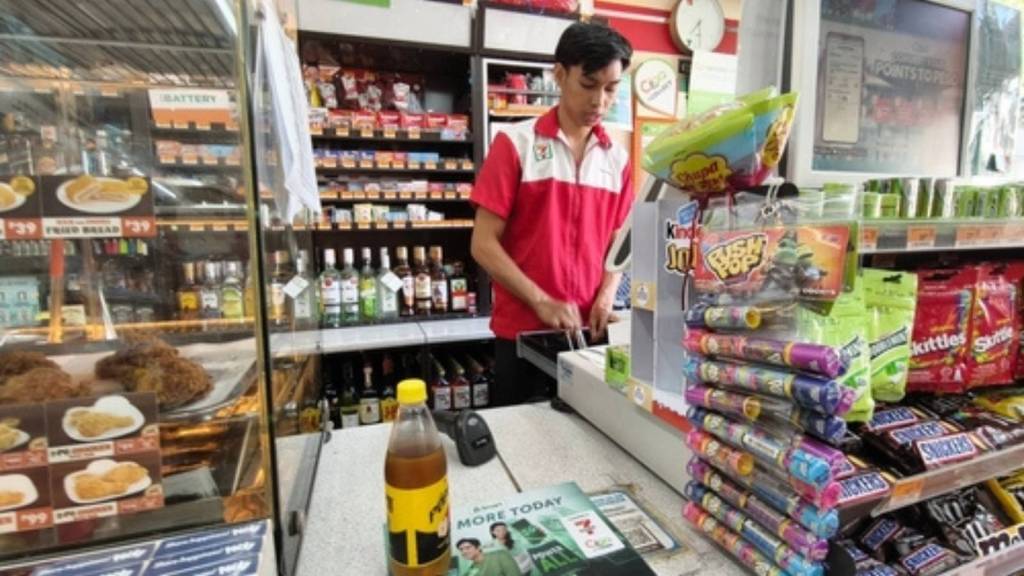 Young man working at convenience store