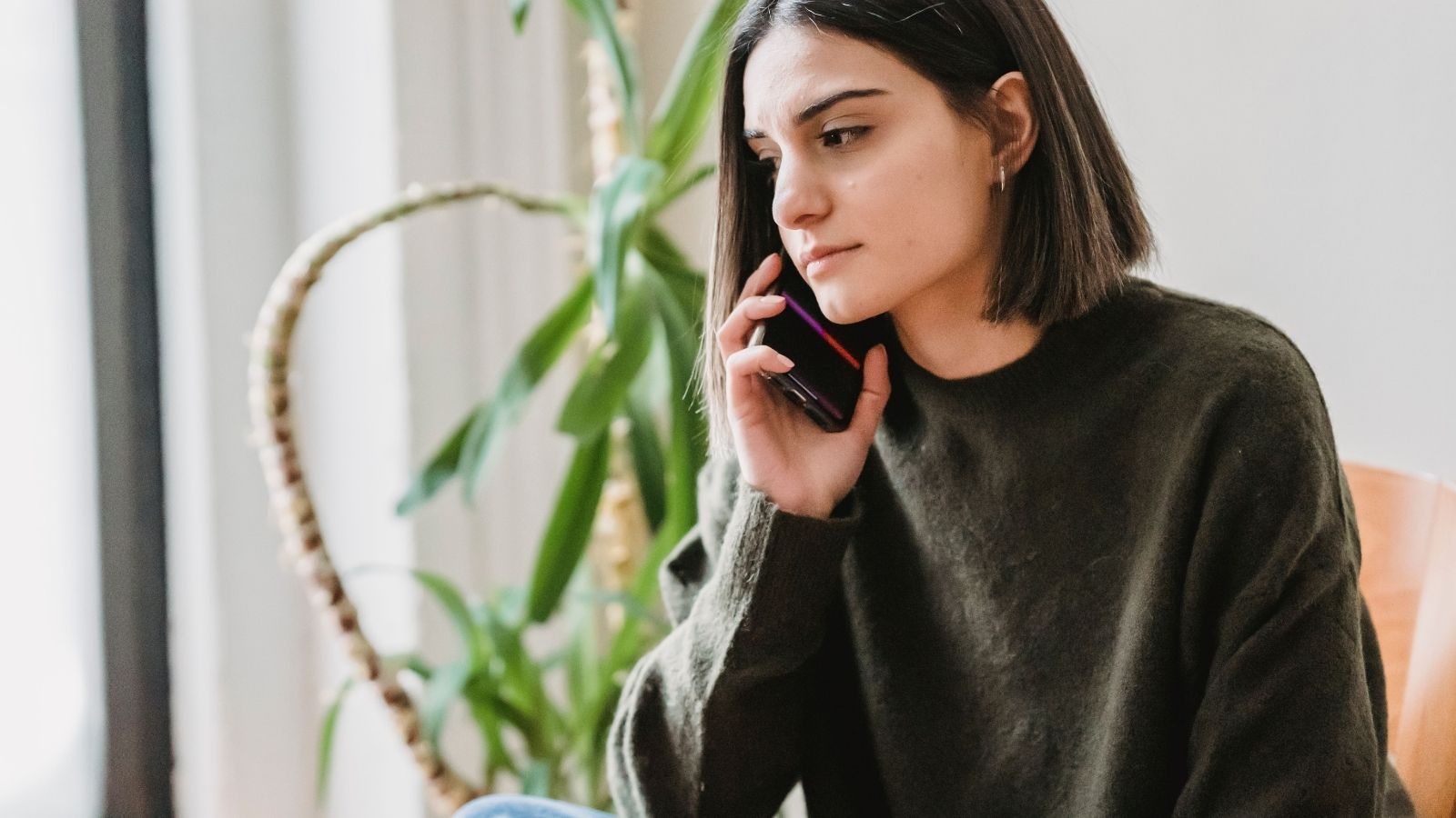 Woman looking upset while on smartphone call