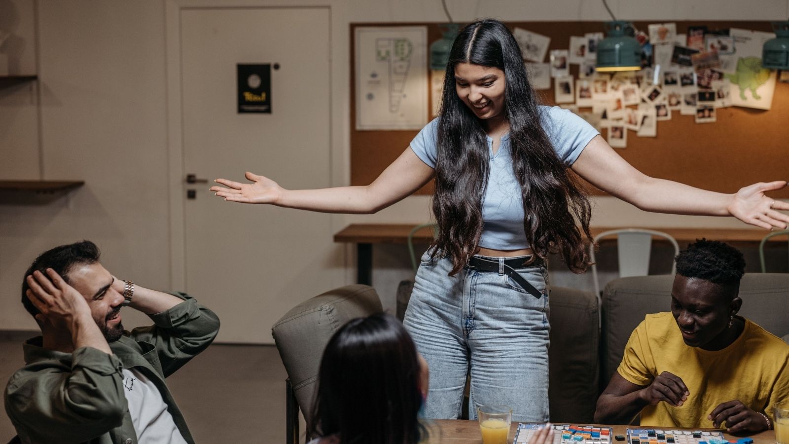 She Pinky Promised She Wasnt the Impostor at the Dinner Table—Then Voted Him Out and Left Him Questioning Her Real Life Integrity Woman standing up at family game night