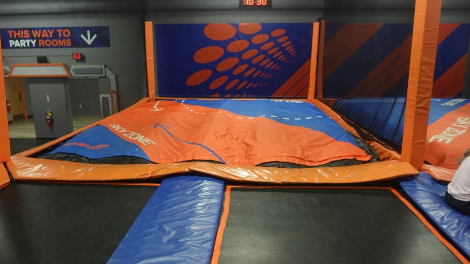 He Refused to Check In a Rude Customer — Now Hes Worried Standing Up for Himself Could Cost Him His Job Orange and blue trampolines at Skyzone