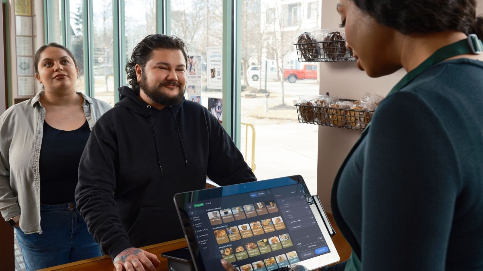 Man proudly standing in front of the cashier