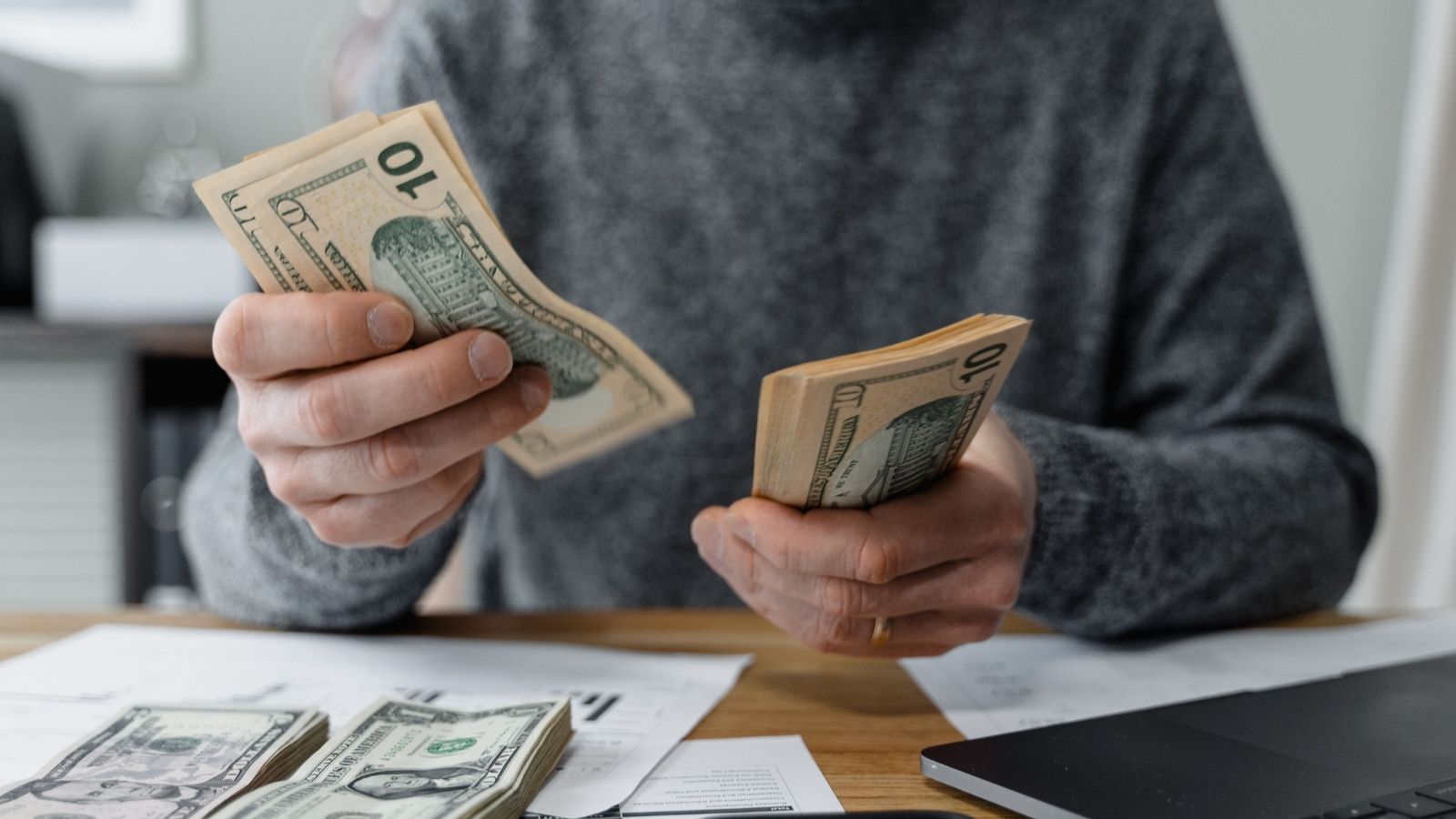 Her Shift Ended with a $105 Register Shortage—Then She Used Time Stamped Video Logs to Prove She Wasnt the One Floating the Drawer Man counting money at a desk