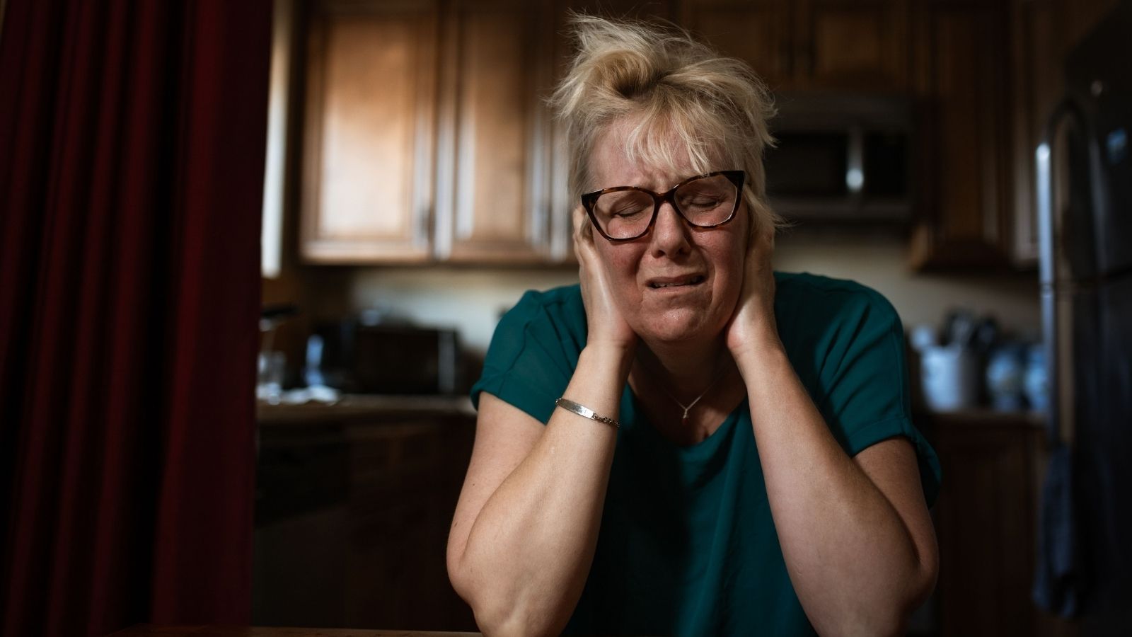 Her Neighbors Music Is So Loud, She Can Hear It Through Headphones — And Police Calls Havent Helped Woman holding her ears to block loud music