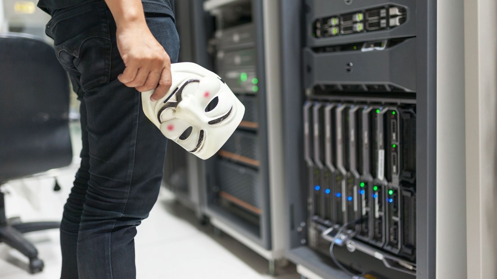 Grocery Store Manager Got Tired Of Begging For A New Server, So He Made Sure The Old One Couldnt Be Fixed Man holding a mask as he looks at the servers