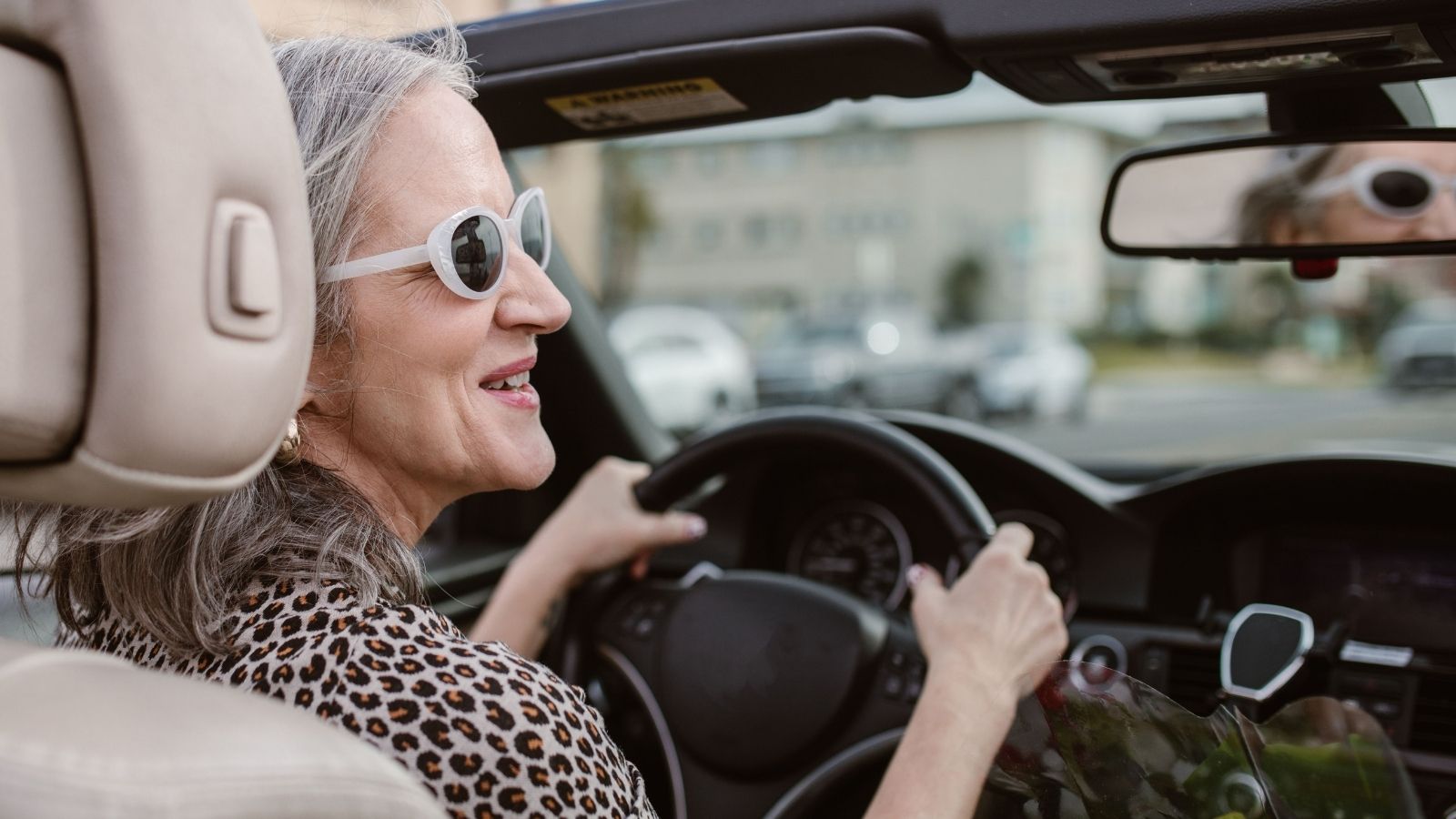 Her Dads Girlfriend Wants a Car for Work — Shes Pushing Back, Citing Vision Problems That Make Driving Dangerous Older woman driving a convertible car