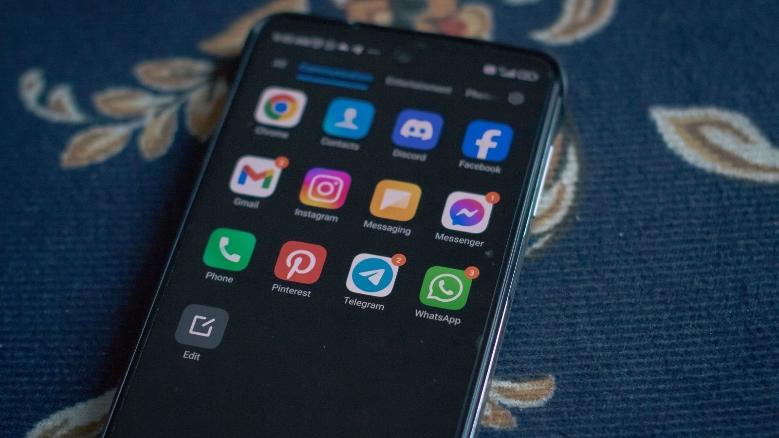 He Banned a New Student From the Groups Discord for Breaking Rules — Now the Student Is Threatening to Report Him Phone laying on a rug with discord app