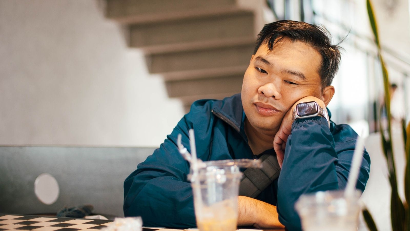 Man sitting at a table bummed out