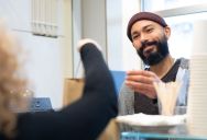 Customer Waits For A Pickup Order While Two Employees Sit On Their Phones, But Other Customers Start Walking Out