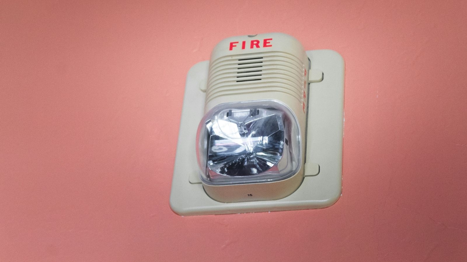 Fire alarm/Smoke detector on pink wall