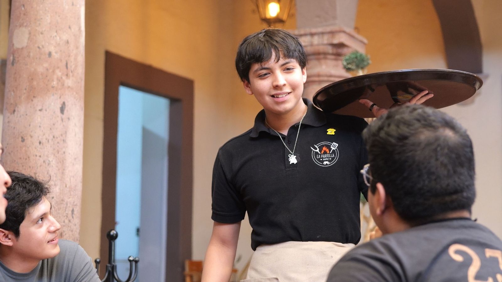 Restaurant Owner Kept Correcting His Server in Front of Customers—Then Took Over His Section Mid Shift Young man serving tables at a restaurant