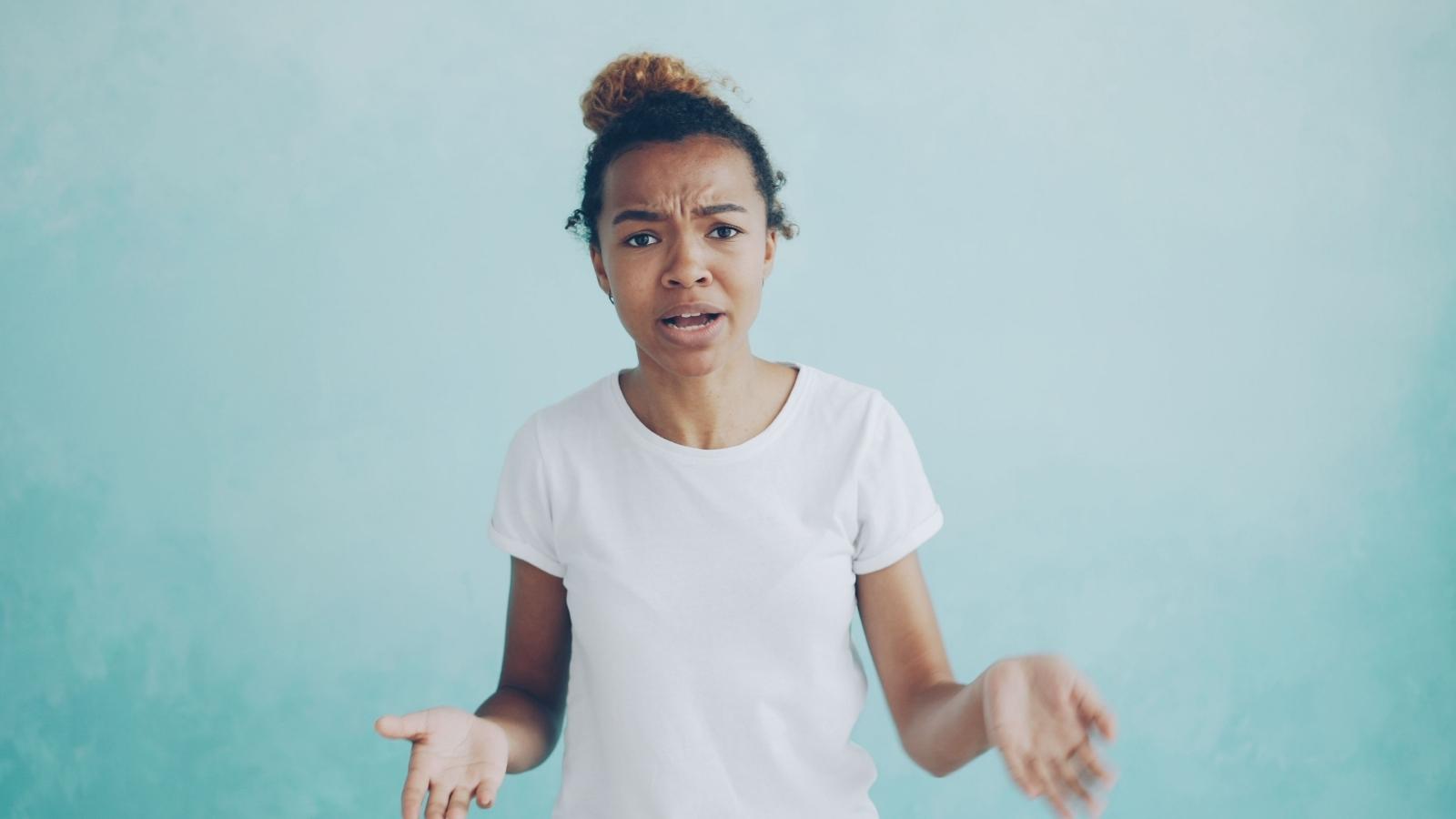 Her Parents Tried To Guilt Trip Her Into Covering A Strangers Vet Bill — She Refused To Pay A Cent woman in white shirt looking upset