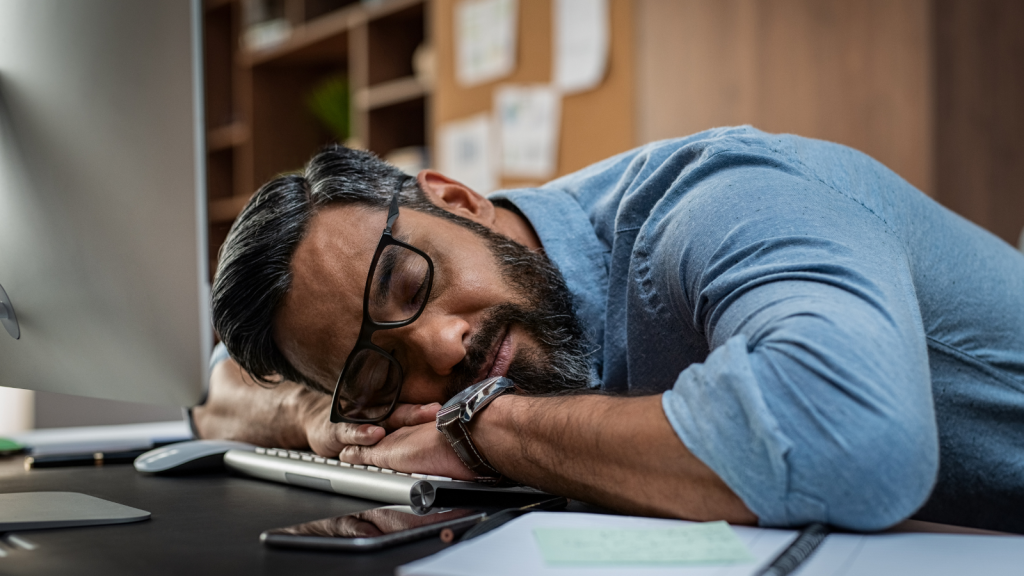 Tired IT worker at desk