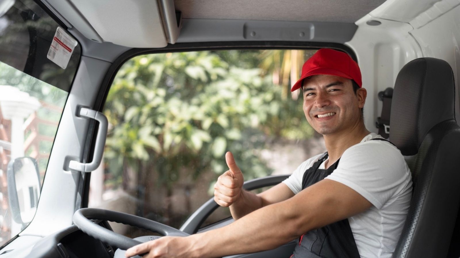 He Mandated Unpaid Drive Time for Work Trucks—So the Crew Parked the Whole Fleet at Head Office and Blocked the Boardroom man in a truck giving a thumbs up