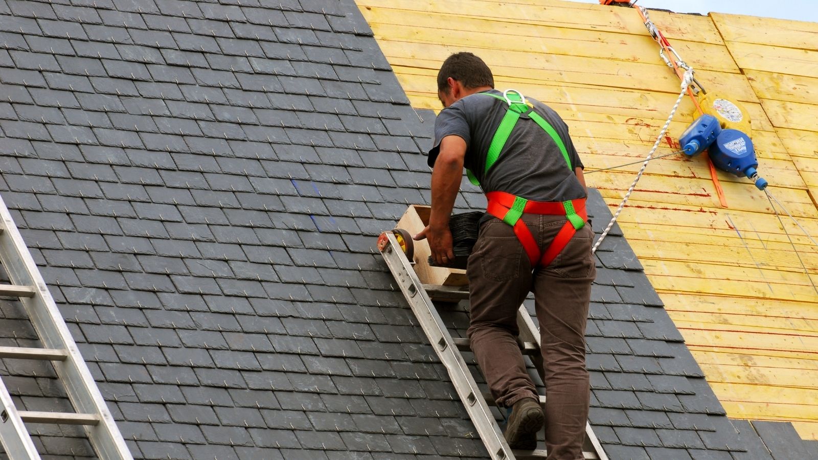 Roofer Violated HOA Rules, Leaving A Homeowner Without A Roof And Unable To Get His Money Back roofer standing on a ladder