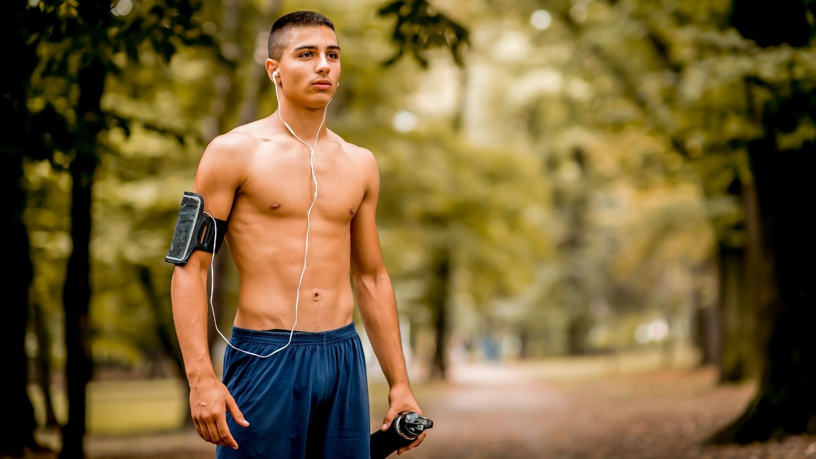 He Maintained a Shirtless Running Habit to Train for Track—Then Executed a Code of Conduct Audit When a Neighbor Called the Police young man standing outside without a shirt on