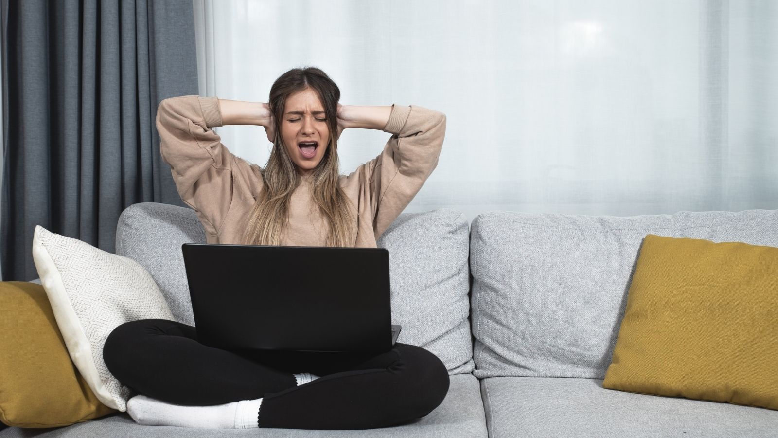 They Thought They Were Moving Into a Quiet Neighborhood — Then One Neighbors Pool Parties Started woman covering her ears while working from home