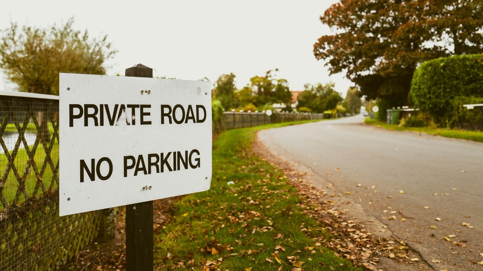 sign that reads "private road no parking"
