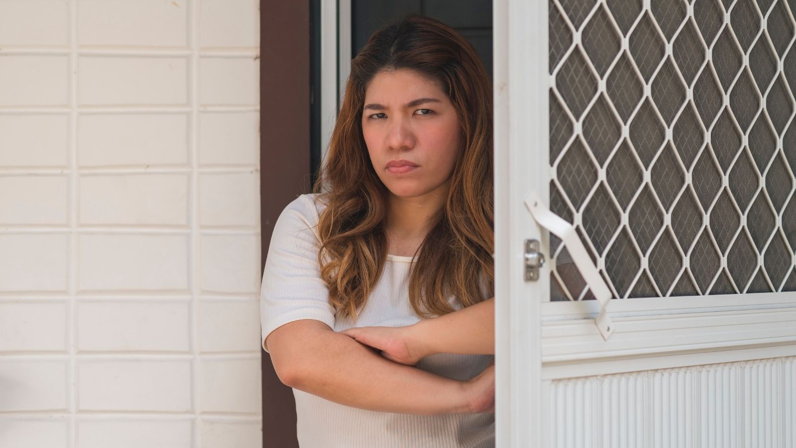 She Paid $30,000 for Rooftop Solar—Then Locked the Front Door When the City Inspector Demanded Access to Her Bedrooms upset woman standing in her front door