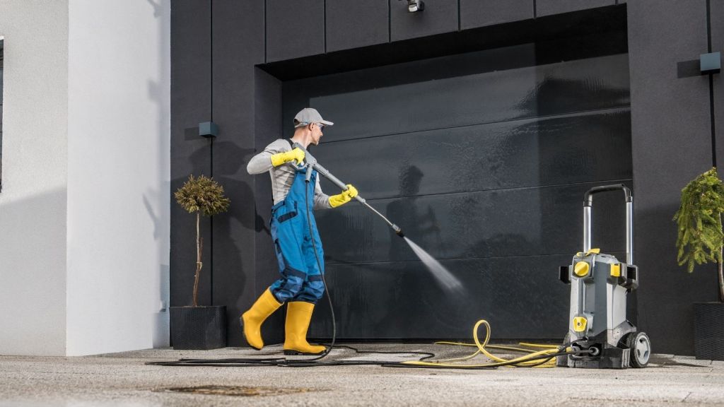 man using a pressure washer