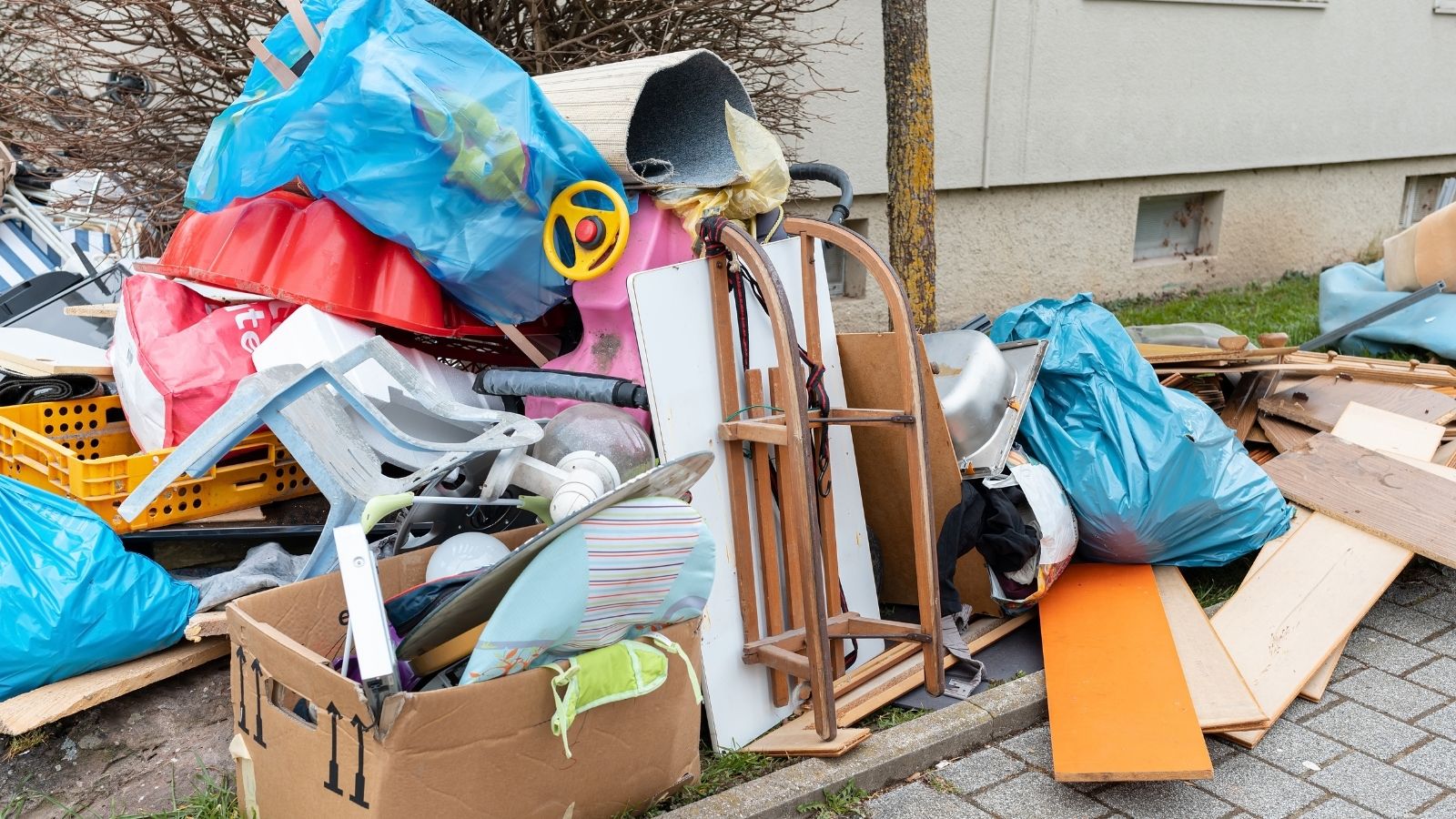 Neighbors Trash Isnt Picked Up Every Week, Leaving Their Home With A Growing Trash Pile And Rodent Problem pile of trash and broken furniture