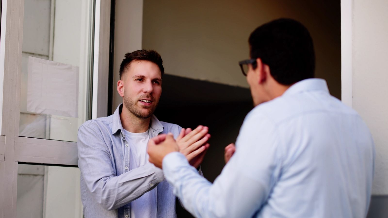 Homeowners Are Angry That Their Neighbor Built Four ADUs, But Theyre Taking Their Frustration Out On The Renters two men arguing in a doorway