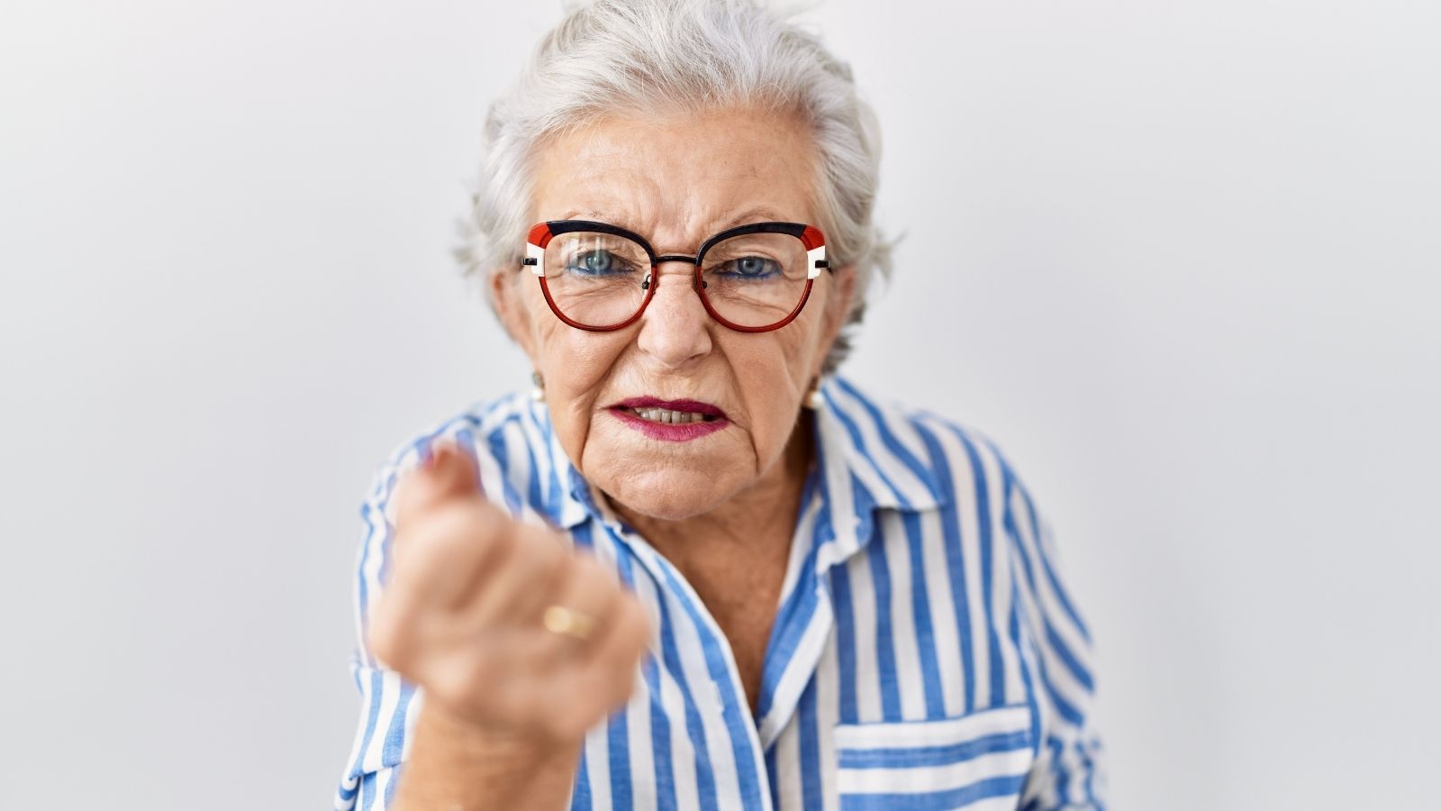 New Homeowners Hired Workers To Renovate Their Home — Now One Neighbor Wont Stop Complaining About Their Vehicles angry senior woman making a fist