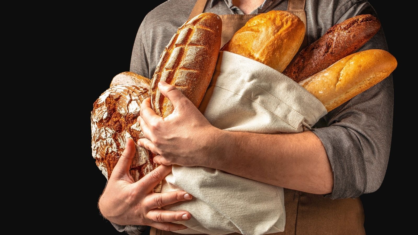 A Local Bakery Owner Caught a Serial Thief Stealing Fresh Bread Daily—Then Arranged a Surprise Delivery with His Biker Regulars person holding a lot of bread