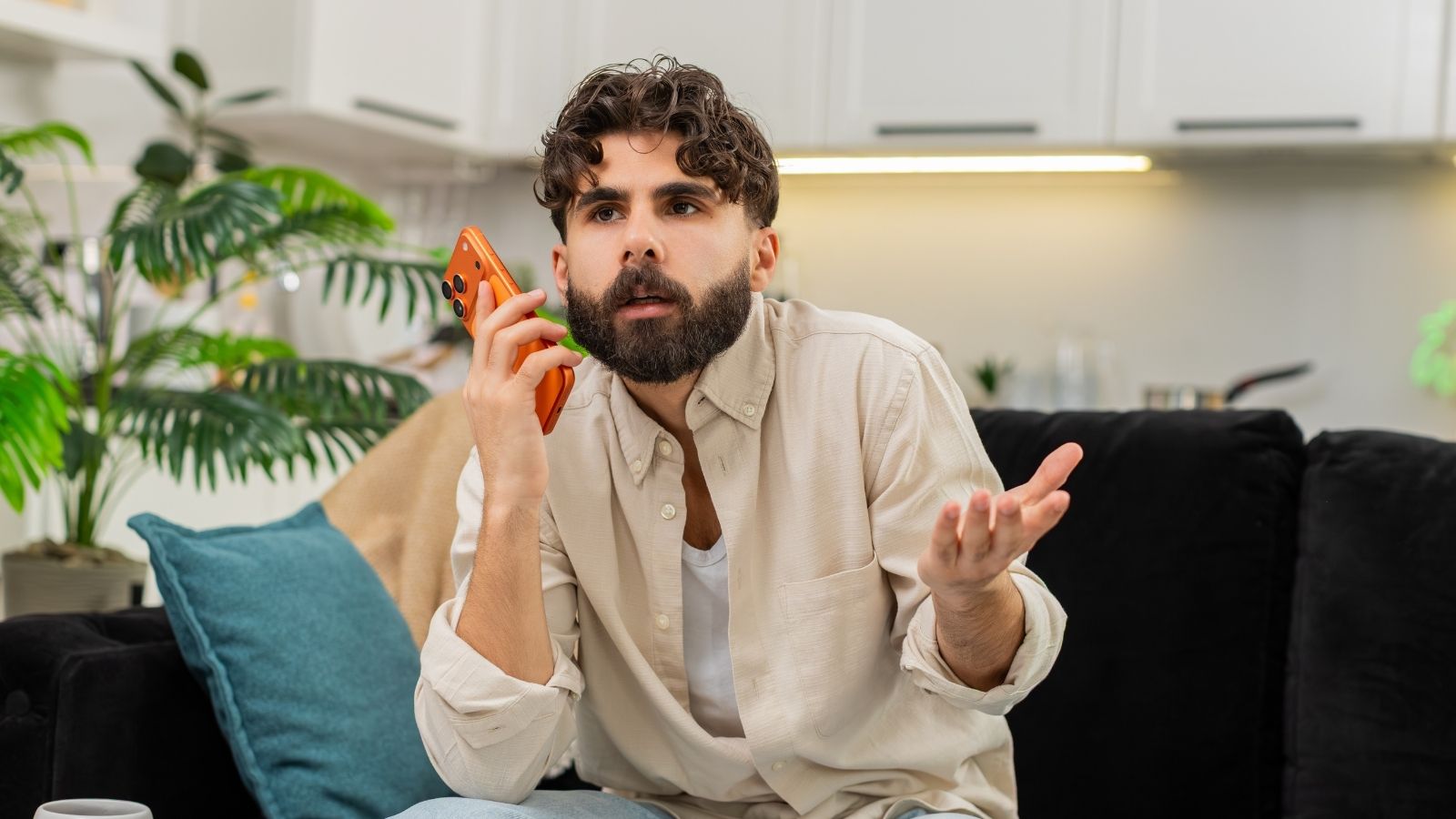 A Money Transfer Company Tried To Scam Him Out Of £20,000 — His Son Knew Exactly Who To Call frustrated man talking on the phone