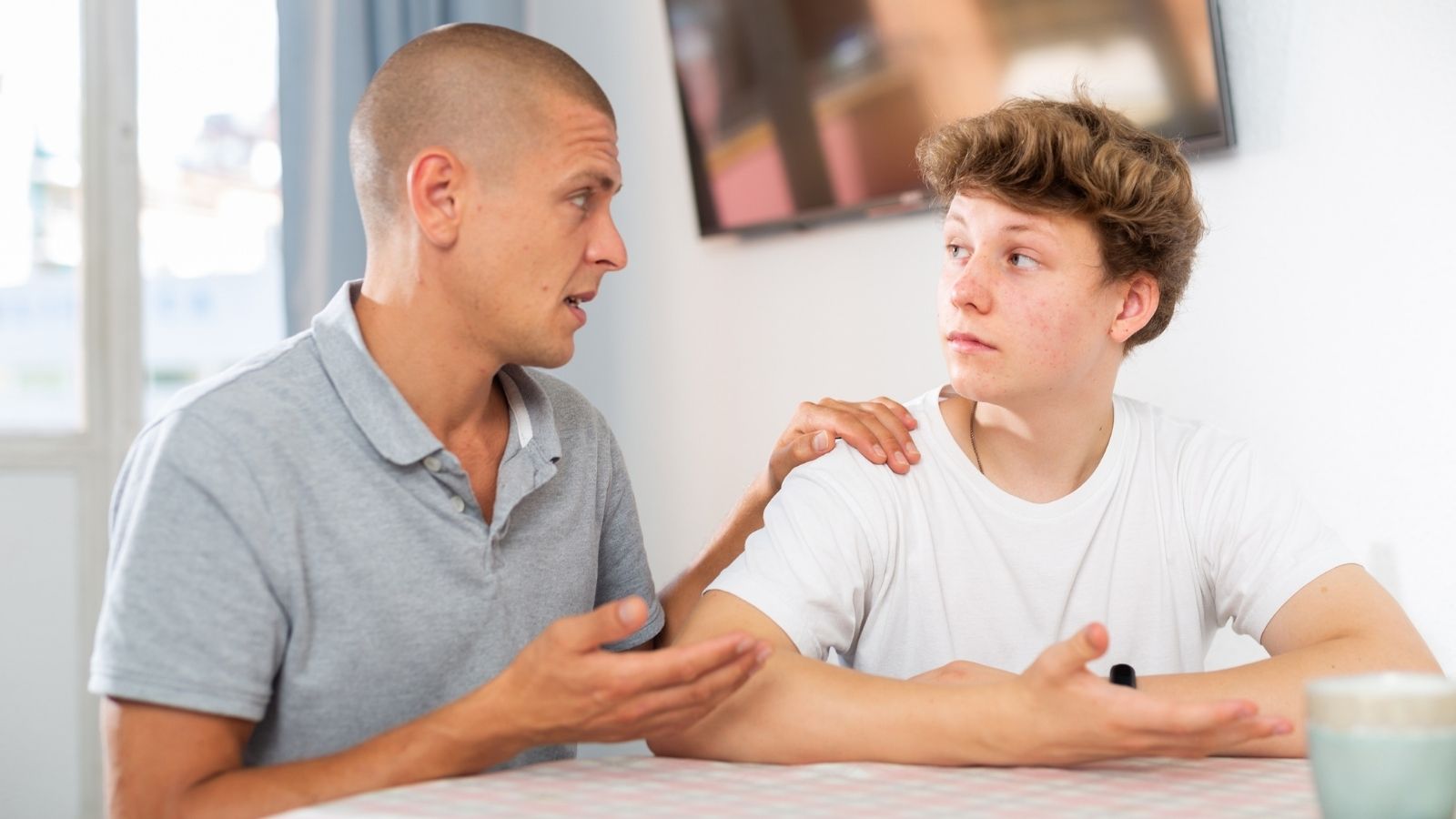 Store Employees Accused Two Teens Of Shoplifting — One Boys Dad Got Them Fired father and teenage boy talking about something serious