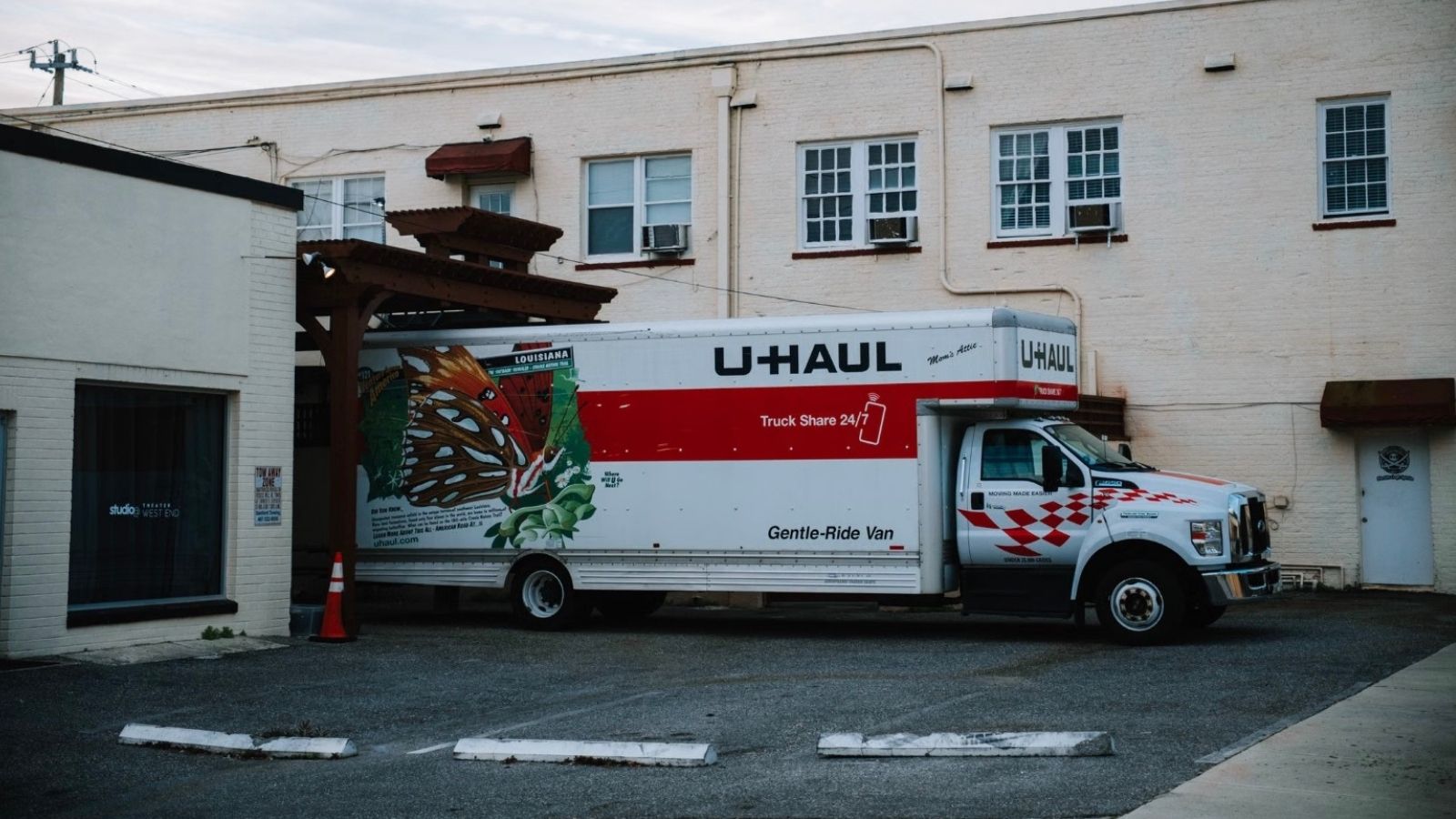 big U-Haul truck between two buildings