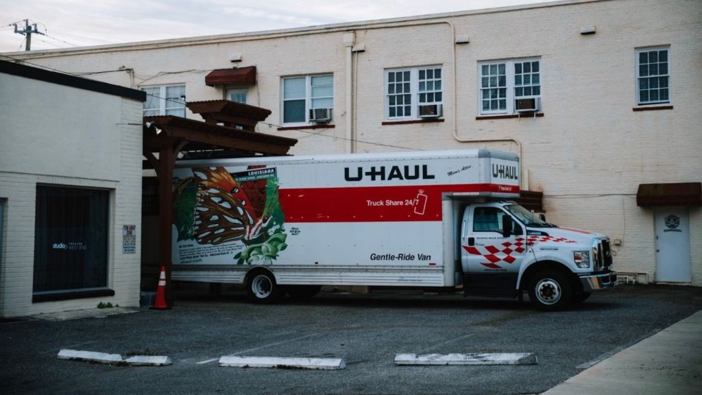 big U-Haul truck between two buildings