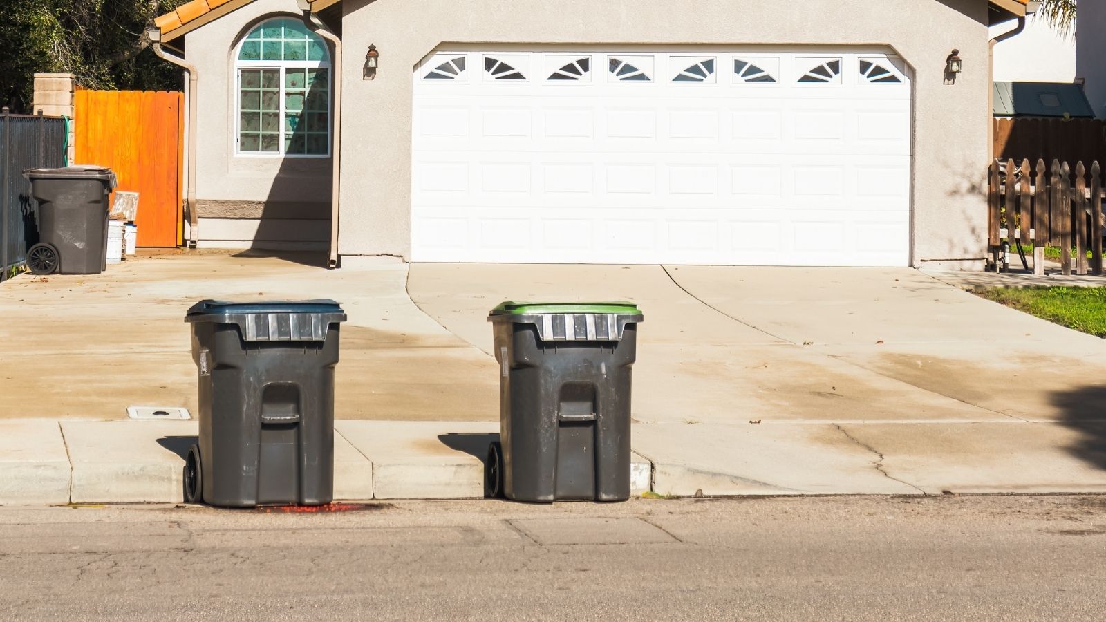 Her Neighbors Get Furious When She Parks In Front Of Their House, But Its Free Public Street Parking trash bins on the street in front of a house