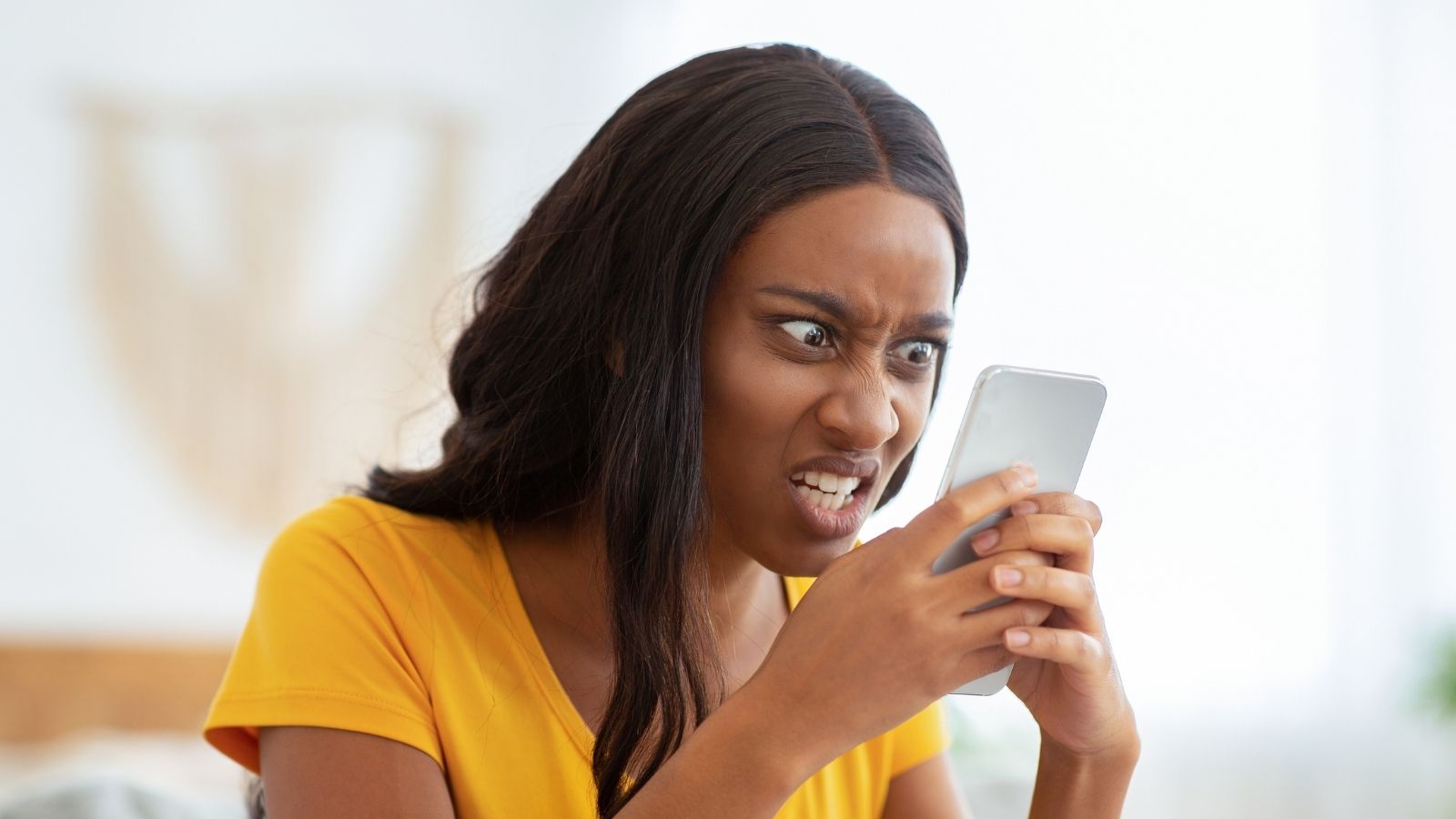 Womans Next Door Neighbor Is Spreading Lies About Her In The Neighborhood Group Chat, But She Doesnt Know What She Can Do angry woman looking at her phone