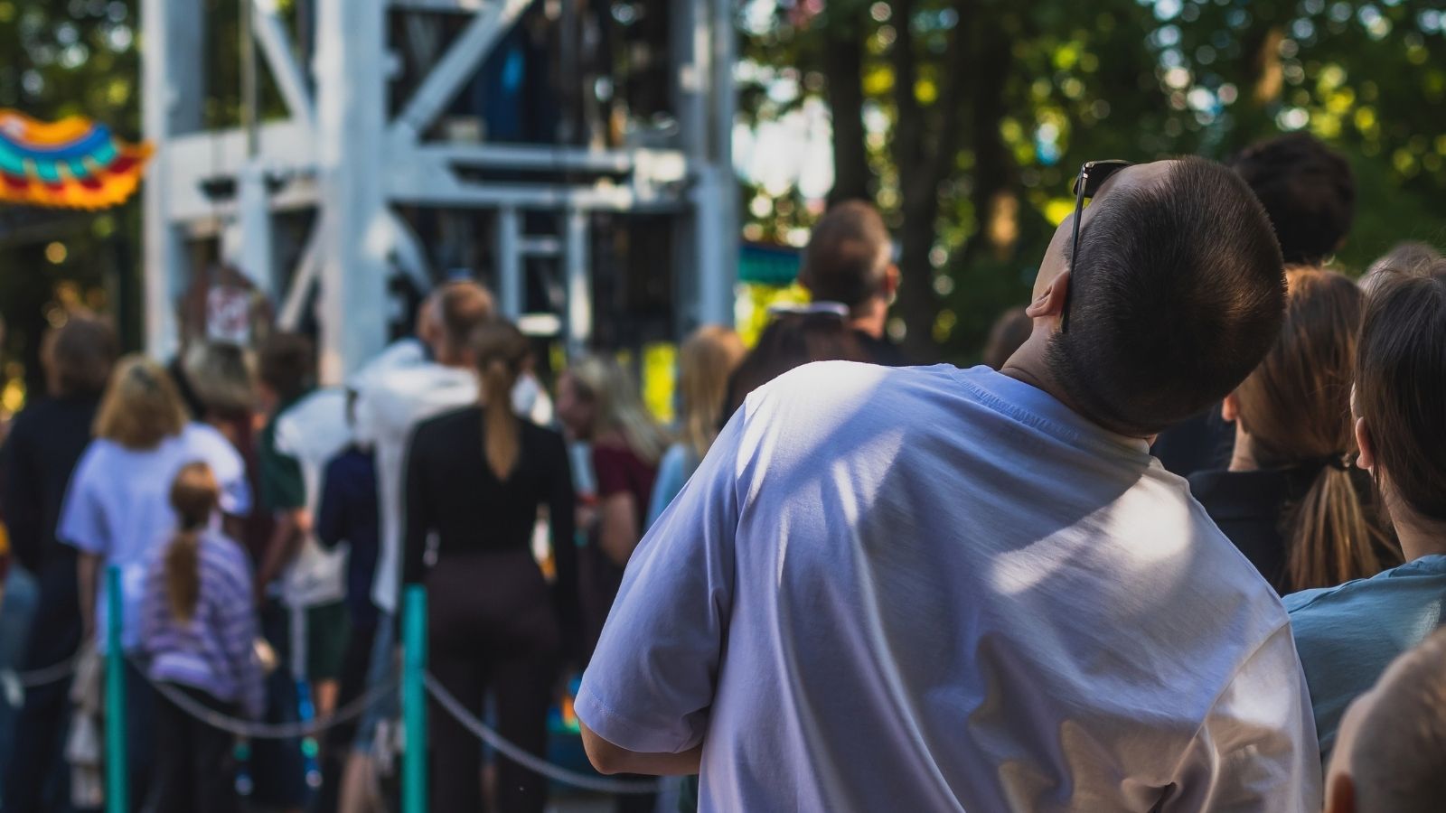 people waiting in line at a theme park