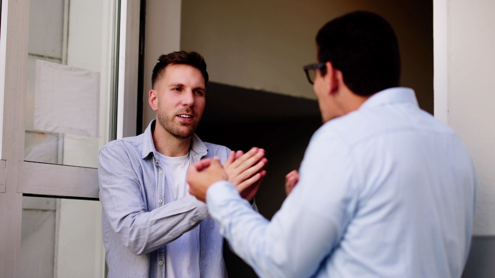 He Did Everything Right, Hiring A Surveyor Before Building His Fence — His Neighbor Moved The Markers Regardless two men arguing in a doorway