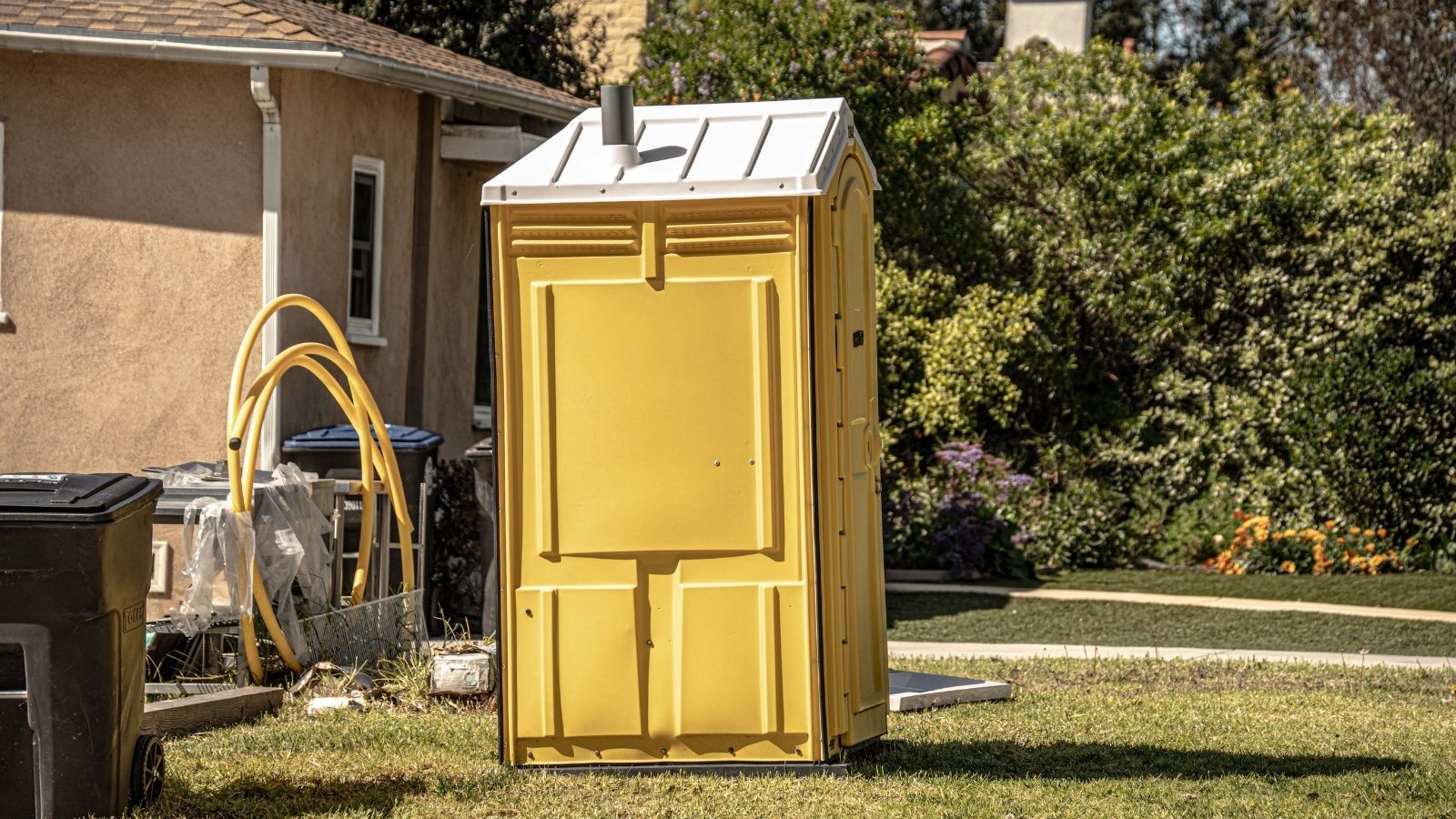 Neighbor Claims Part Of A Familys Property Even After A Survey Confirms The Boundary, So Theyre Forced To Use A Porta Potty portable restroom outside a house