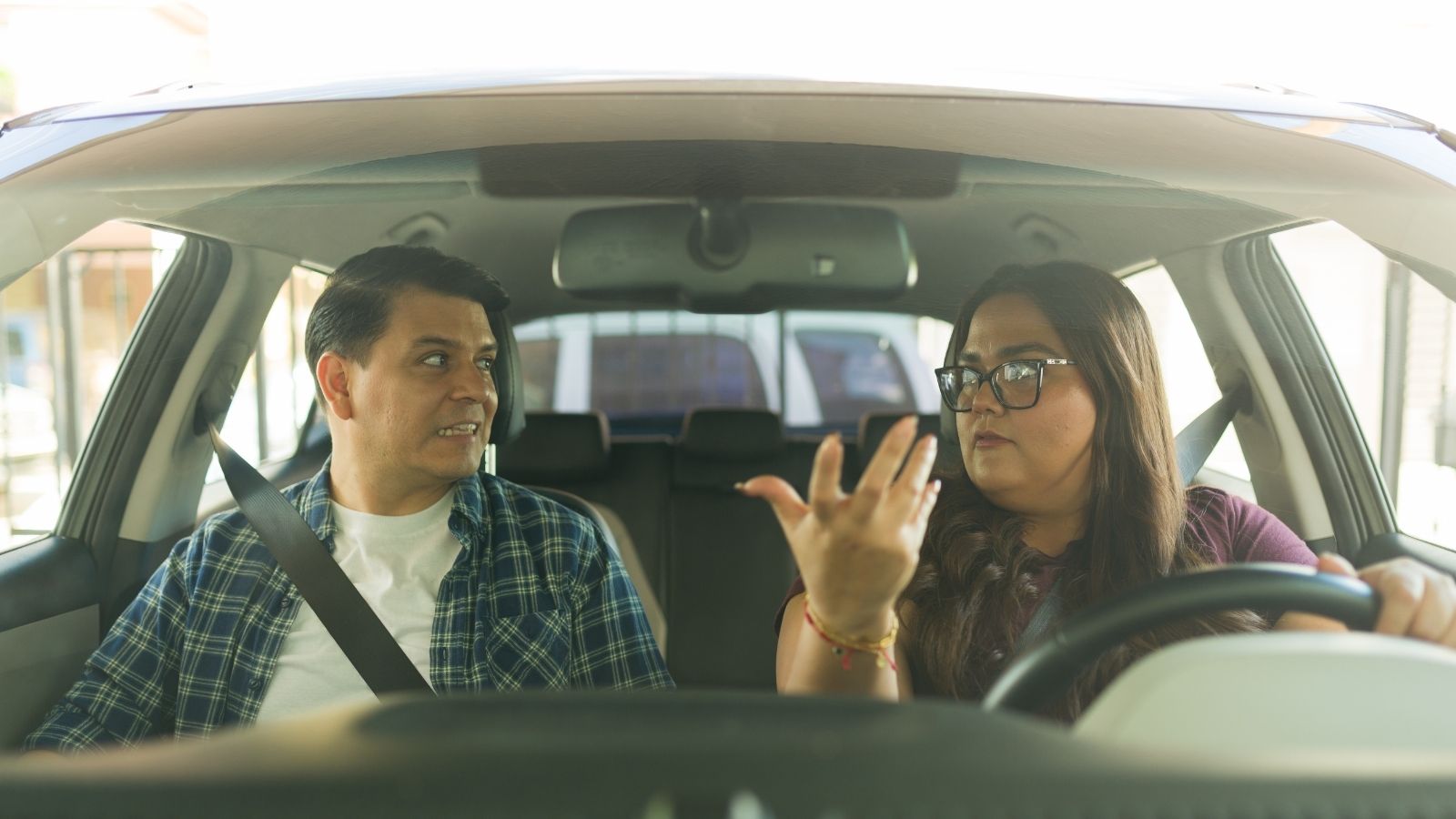 She Stood in a Prime Spot to Hold It for Her Friend—So Another Driver Nosed Her Sedan Right into the Space Anyway couple arguing in the car