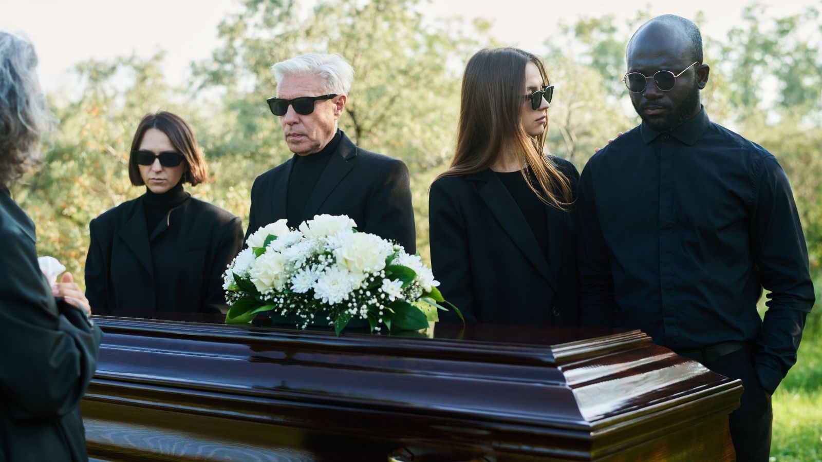 He Was Furious At How His Mom Treated His Dying Father, So He Left Her Out Of His Obituary Entirely mourners at a funeral