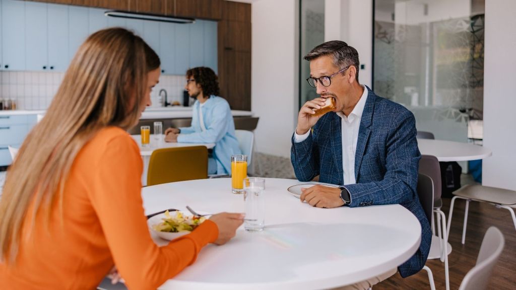 coworkers eating lunch in break room