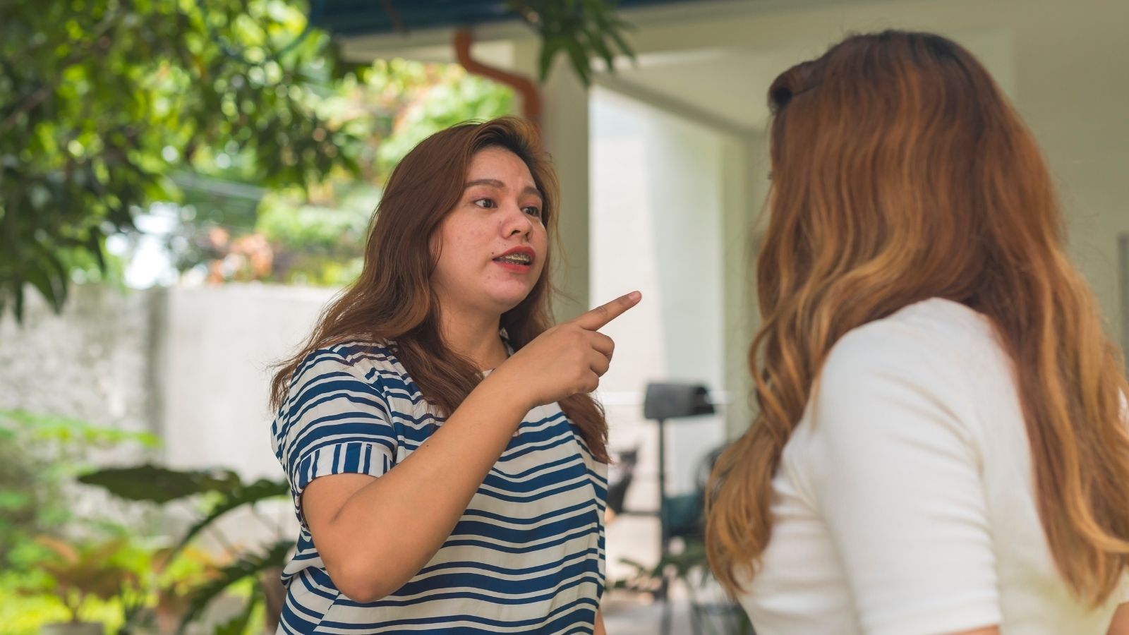 Her Neighbor Keeps Blocking Her Driveway With Her Car, But Somehow Shes The One Who Ends Up With The Parking Ticket two women arguing outside