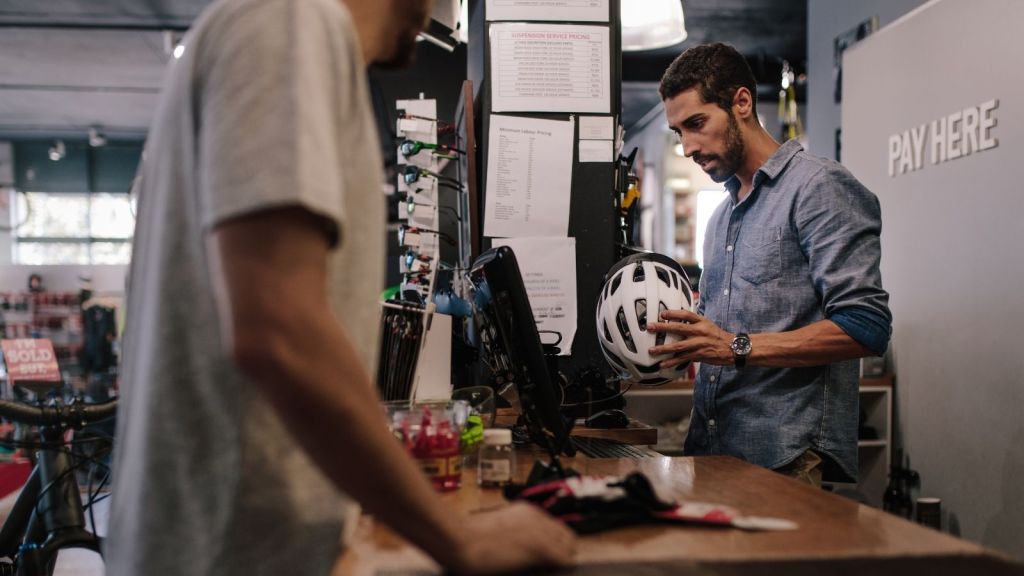 cashier helping customer at a sports store