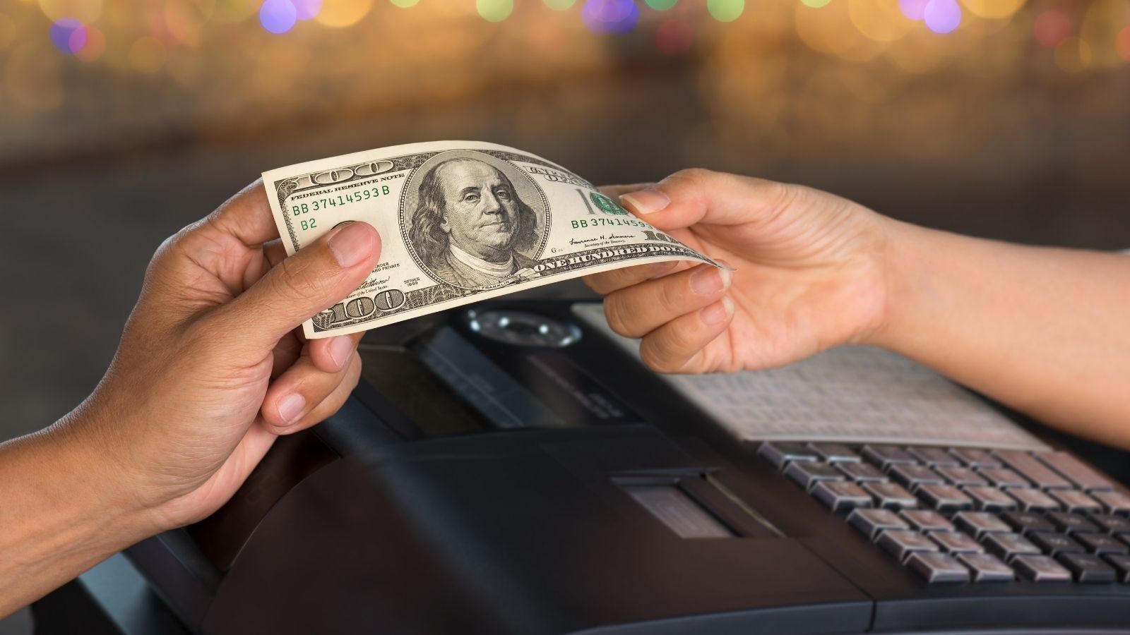 customer paying with 100 dollar bill